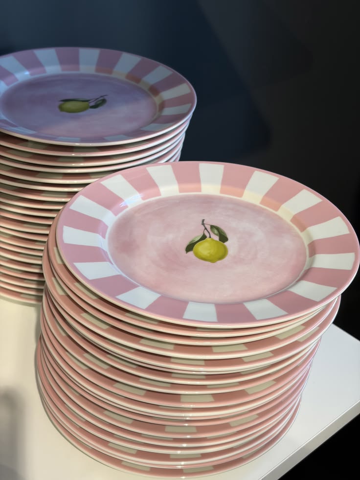 Pink striped ceramic plates stacked for the table