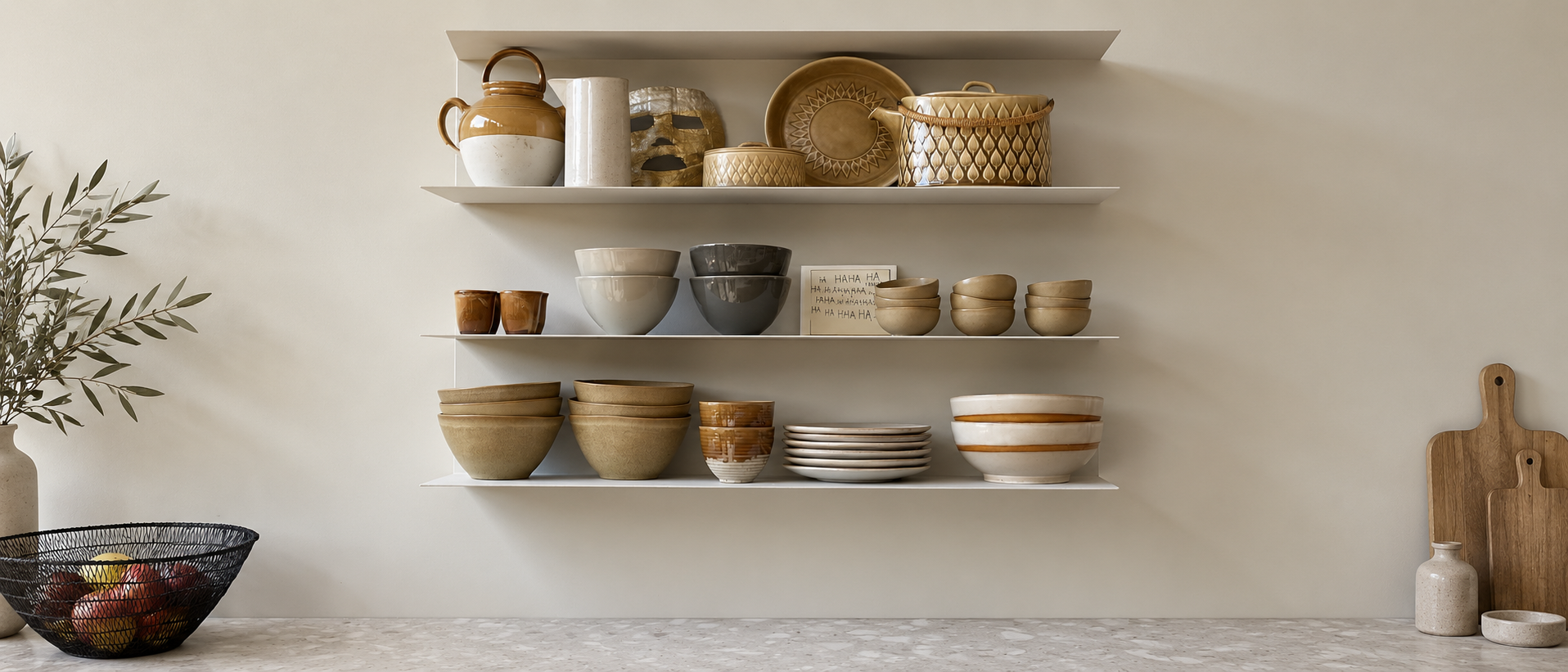 Shelves displaying a collected mix of ceramic tableware
