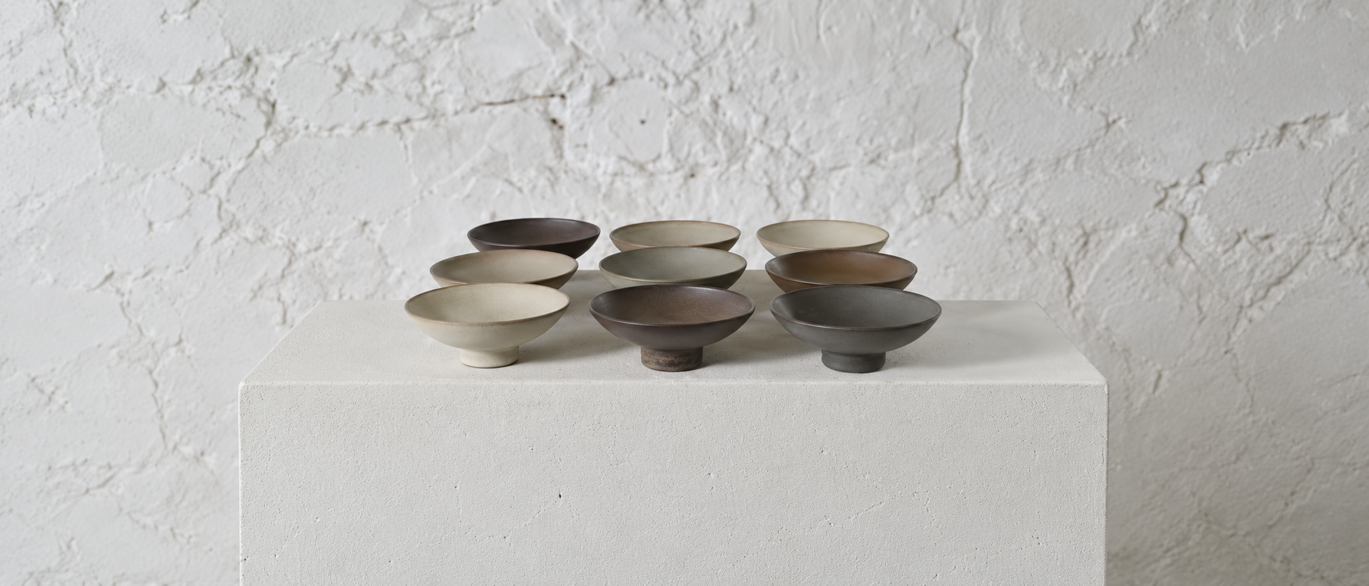 Minimal ceramic bowls arranged in natural neutral tones